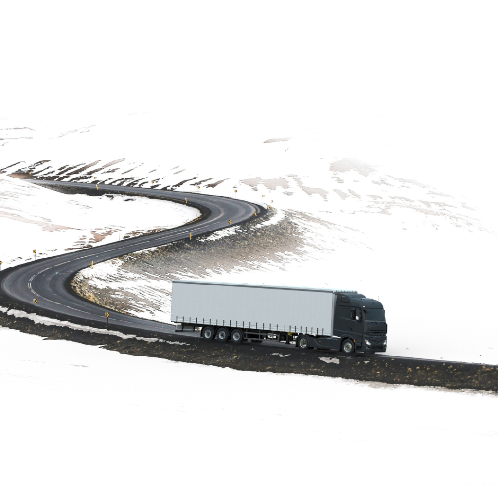 En la imagen se muestra un camión navegando una carretera rodeada de nieve